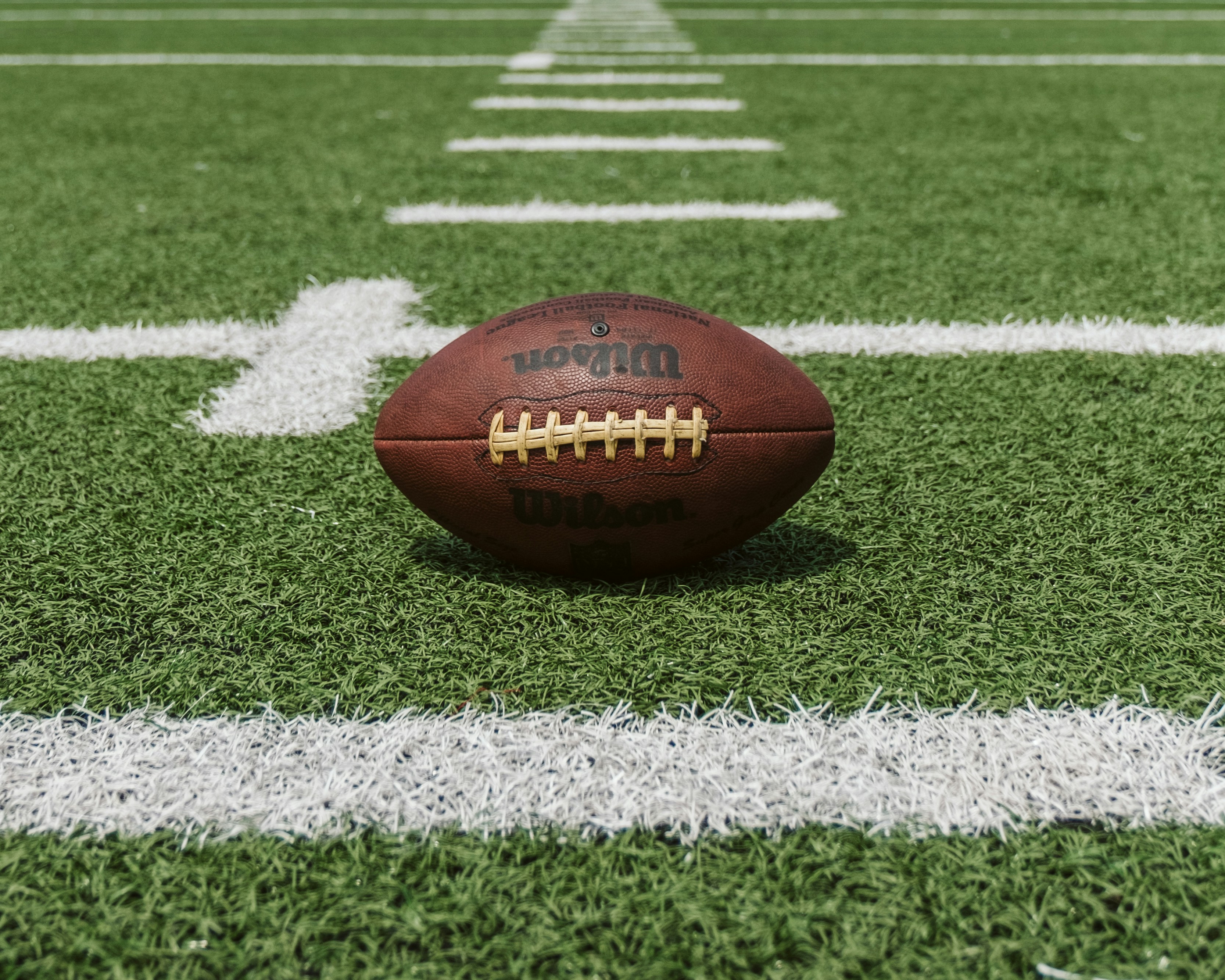 a football sitting centered in the football field