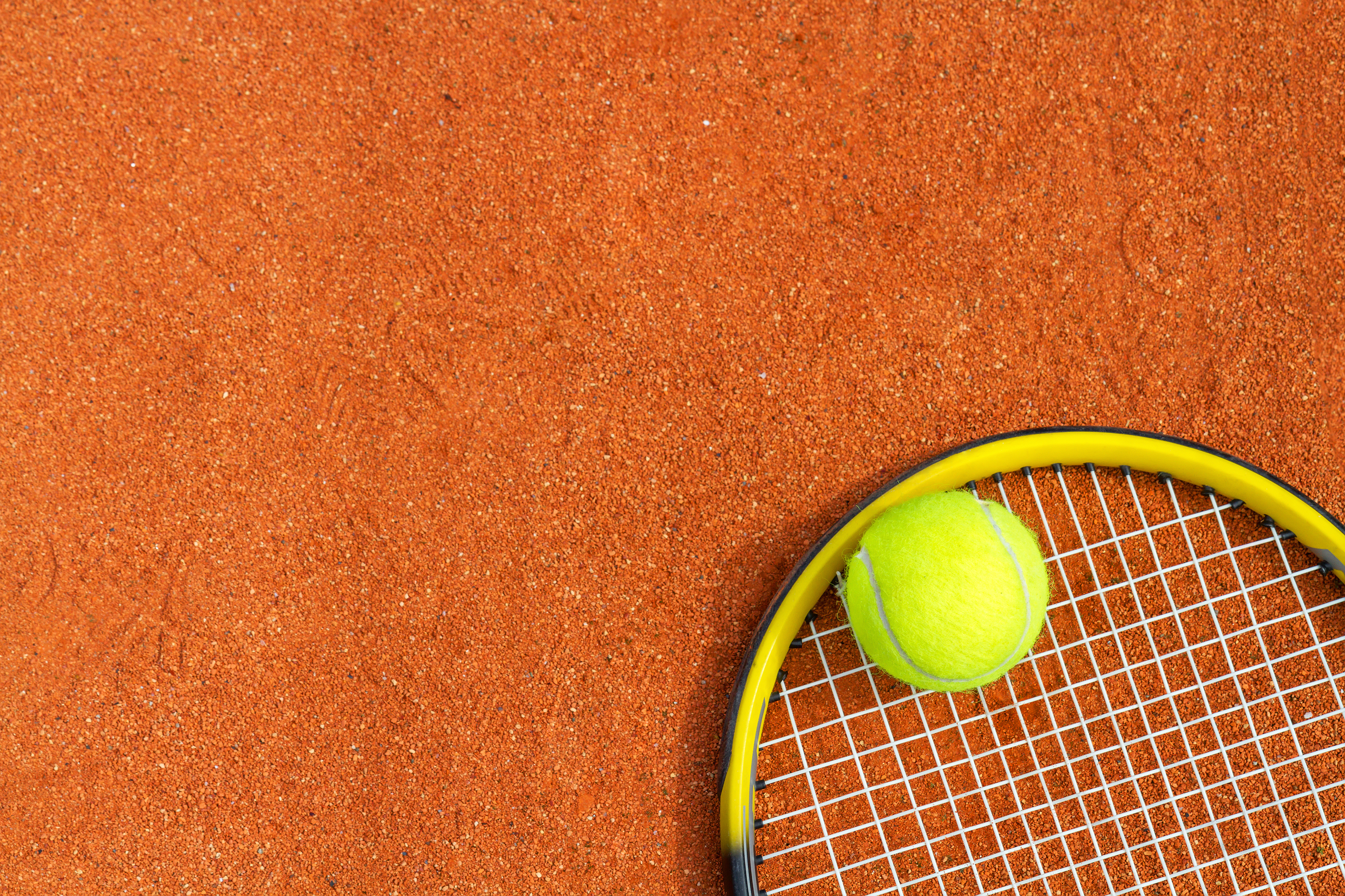 tennis equipment on a brown surface