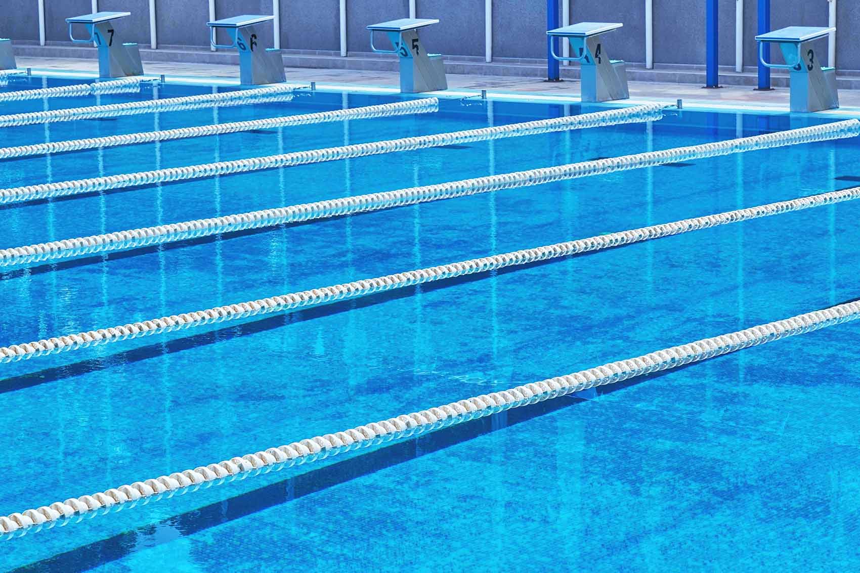 an empty swimming pool with lanes