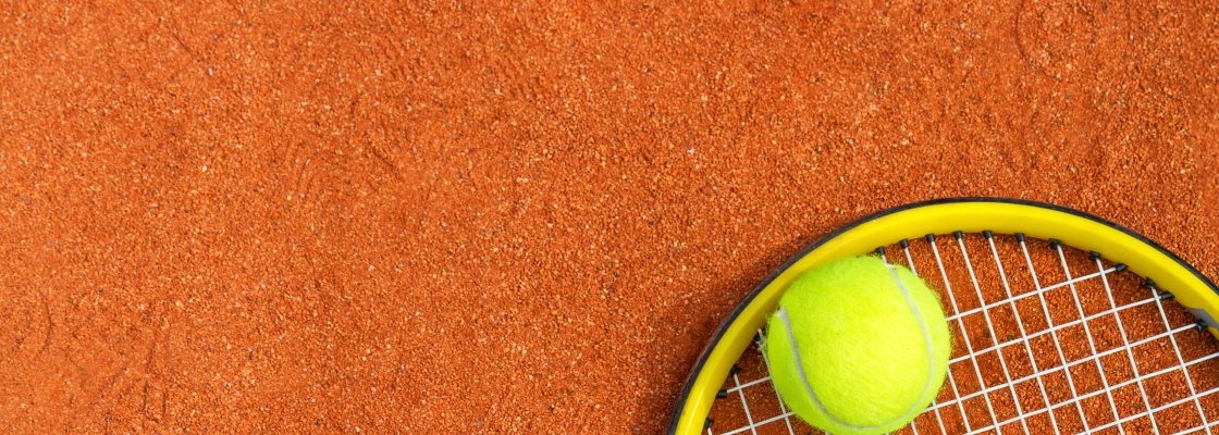 tennis equipment on a brown surface