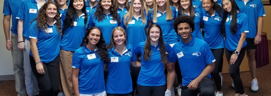 A group of student athletes in blue shirts